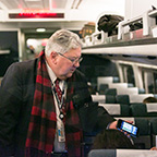 <i>Downeaster</i> conductor scanning eTickets, 2016.