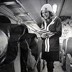 Passenger service representative talking with passengers, 1970s.