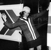 Passenger service representative waving, early 1970s.