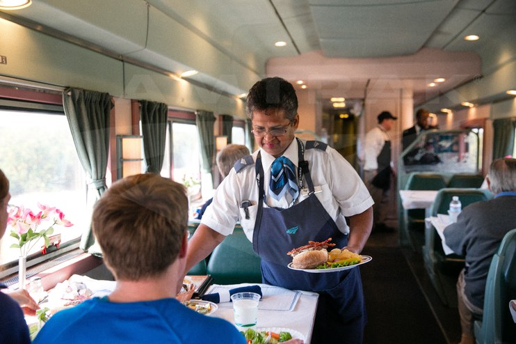 Service attendant at work in a Heritage dining car, 2015.