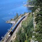 Western long-distance train along a river, 1980s.