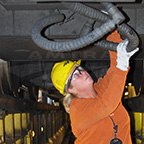 Working in an inspection pit, 2010.